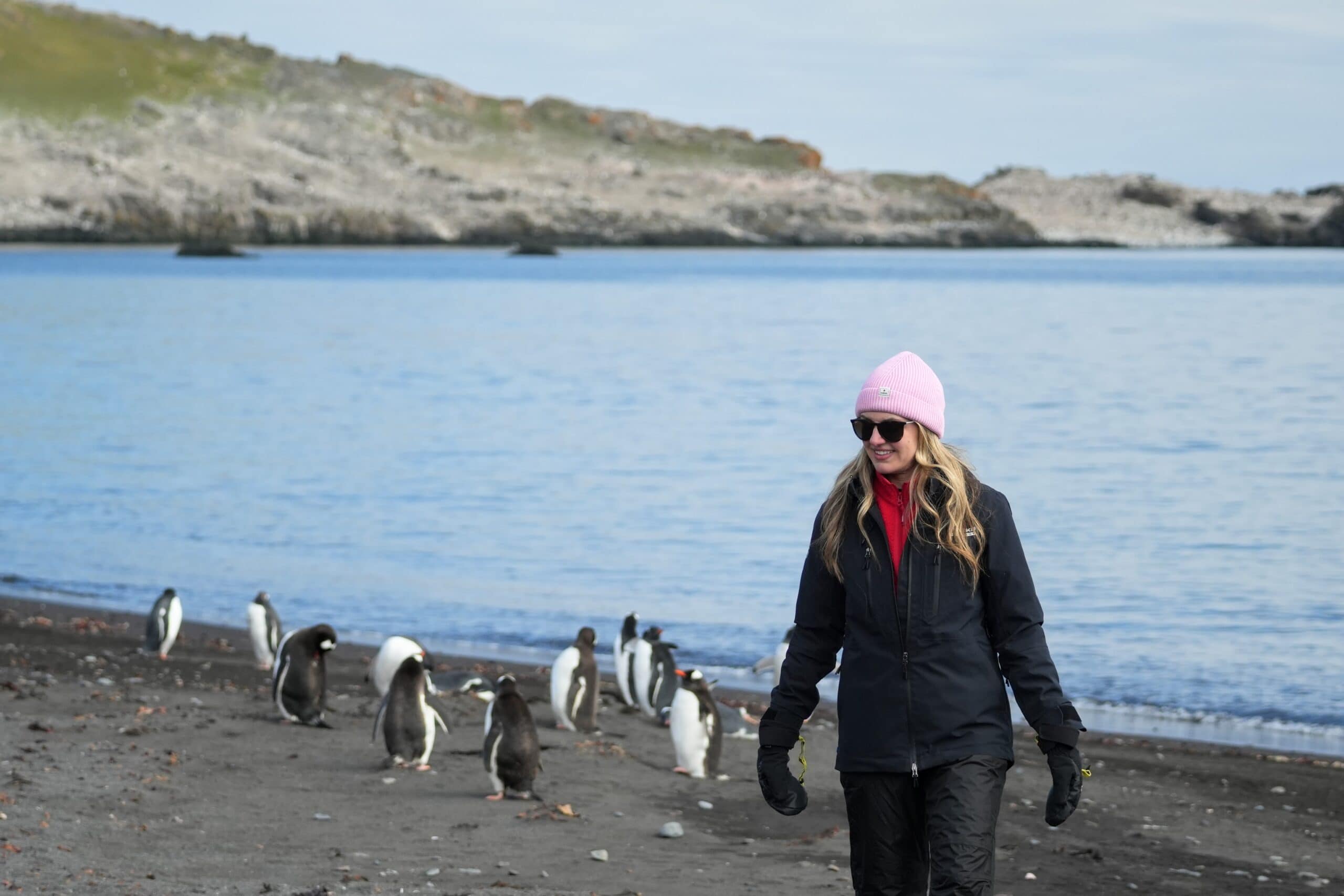 meghan on the beach with penguins Antarctica the 7th continent Shetland Islands